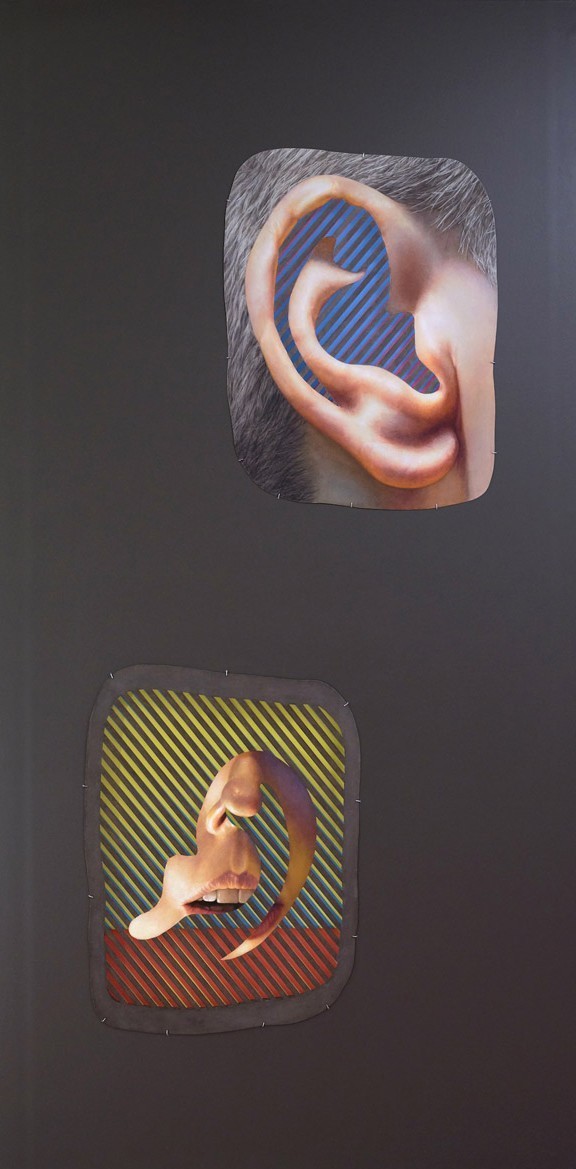 Grey wall with two cut-outs, one of an ear and one of a mouth. Blue are inside the ears, and the mouth is surrounded by a block of yellow stripes, followed by some blue.